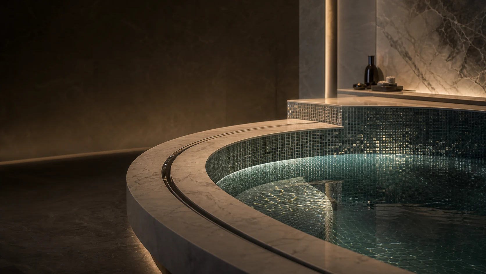 Luxury wellness environment with curved glass mosaic, natural stone and precision surface detailing.